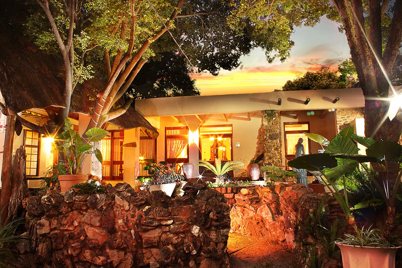 The guest house's stone entrance lit up at dusk